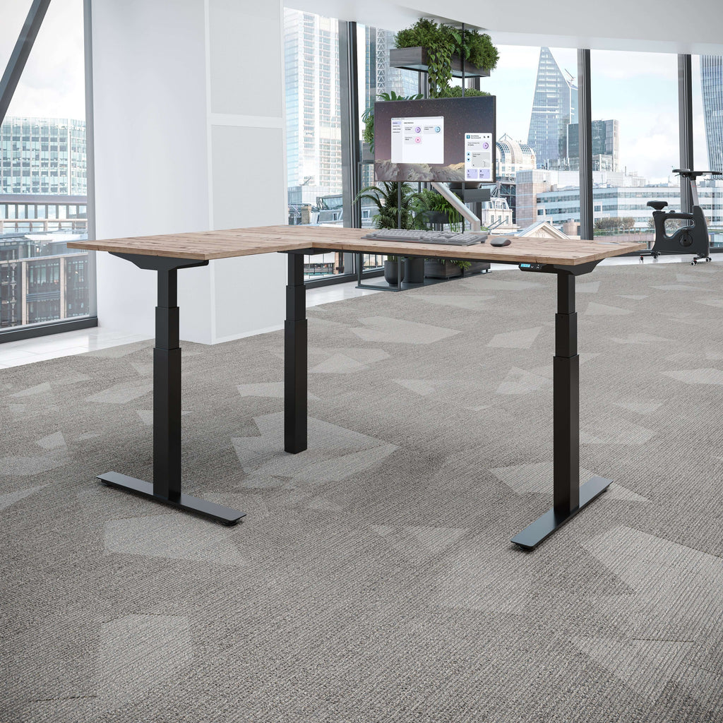 Smart standing desk corner shown in a modern office with a sleek design and adjustable height features.