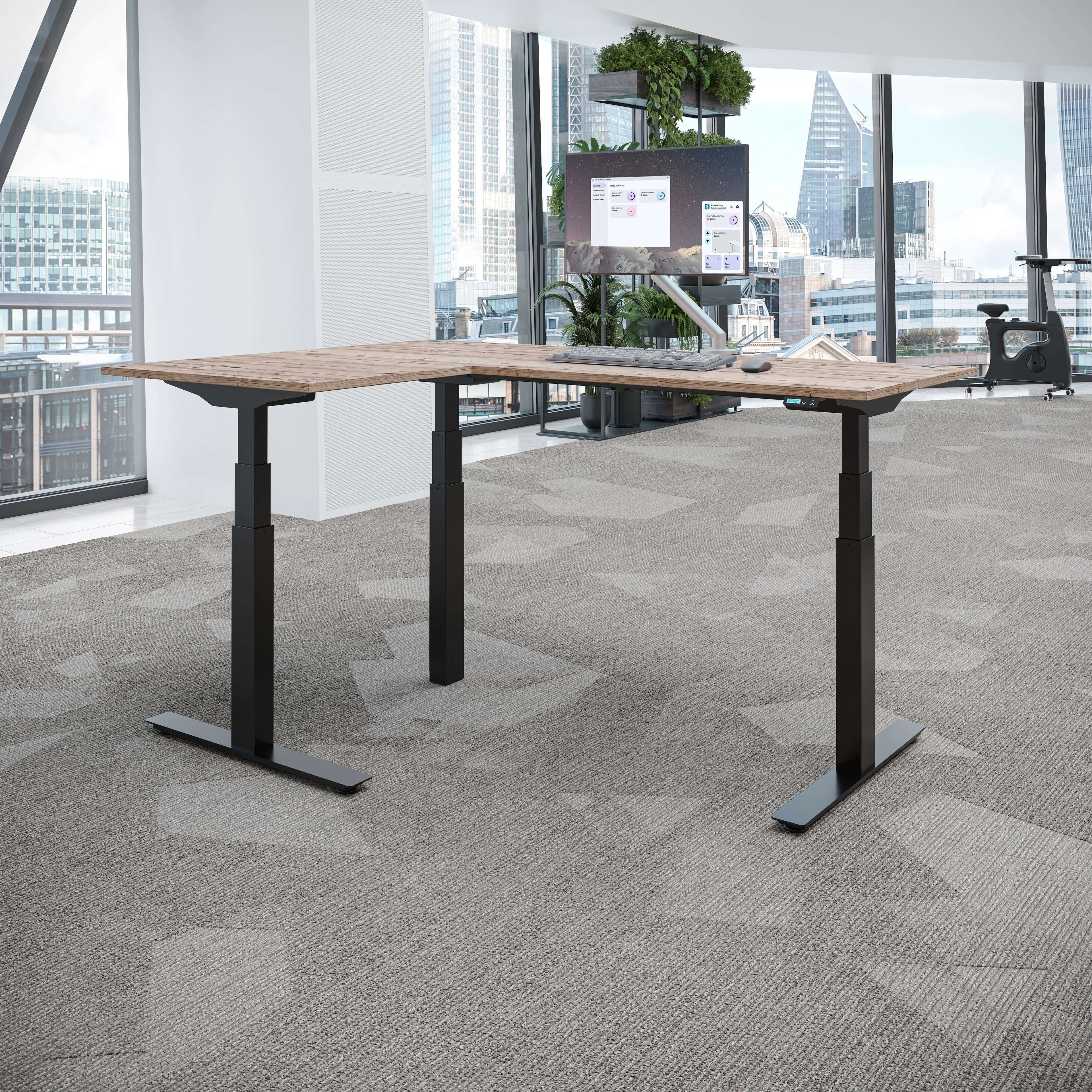 Smart standing desk corner shown in a modern office with a sleek design and adjustable height features.