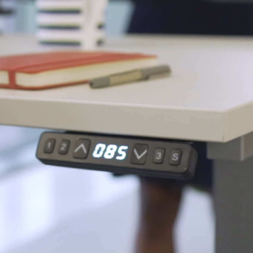 Control panel of a dual motor electric standing desk displaying height settings and features.