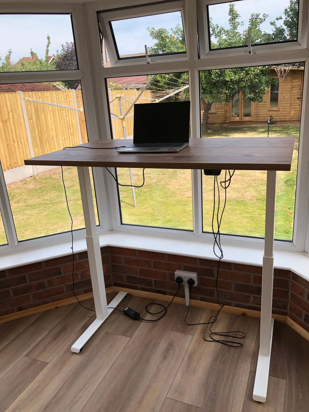 iLohas 2 Dual Motor Electric Standing Desk in a bright room with a laptop on it
