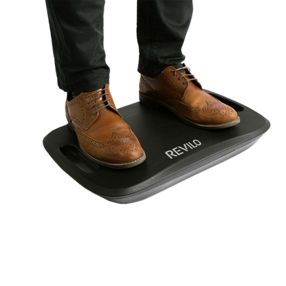 Person standing on Revilo Coreboard Plus balance board for posture improvement - Black.