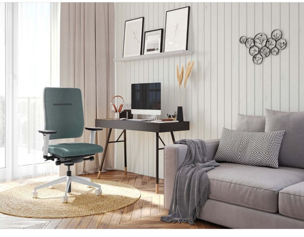 Ergonomic swivel task chair in a modern home office setting with a desk and cozy sofa.