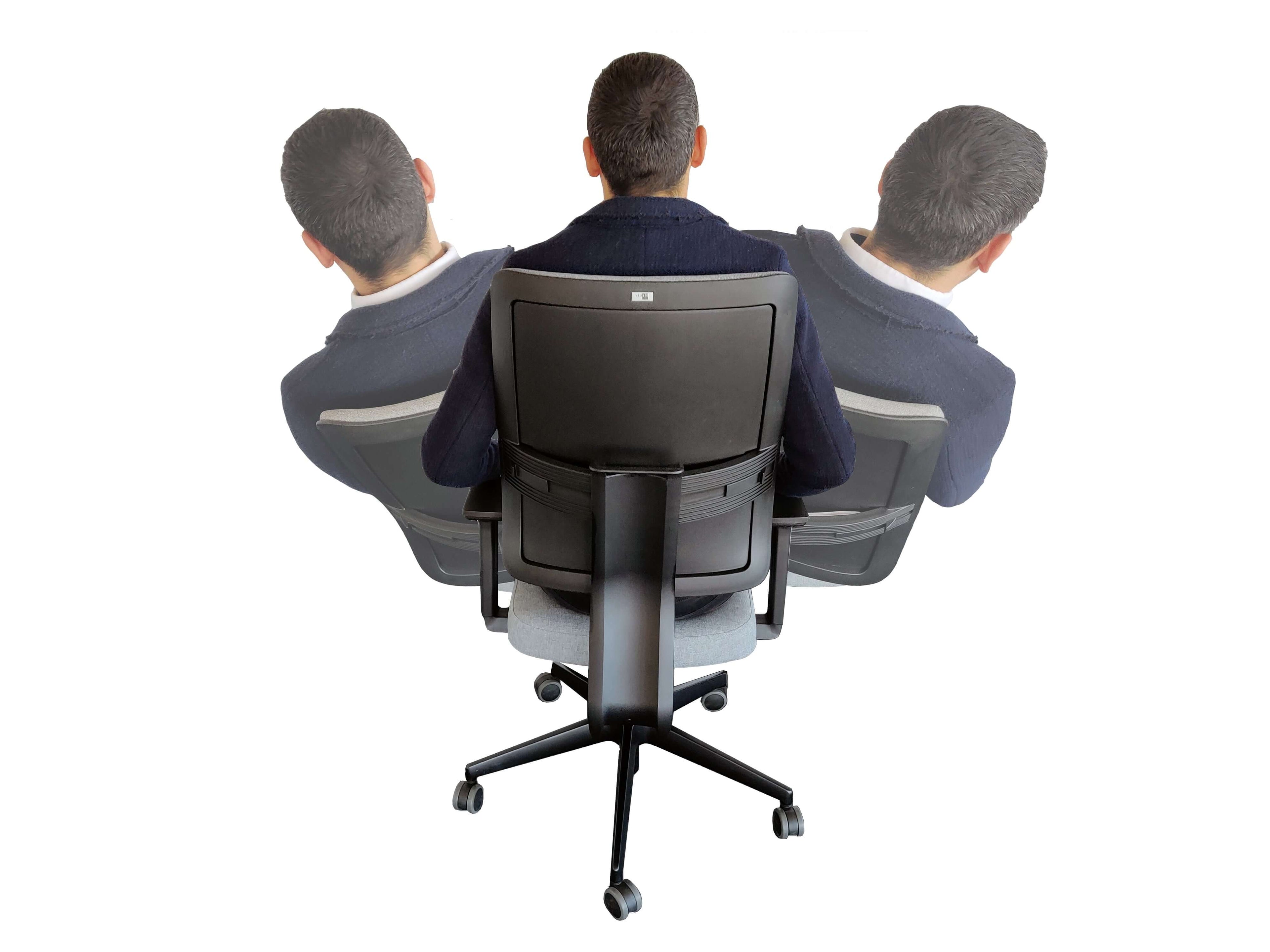Ergonomic swivel task chair shown from behind with a person demonstrating its 3D dynamic seating and swivel functionality.