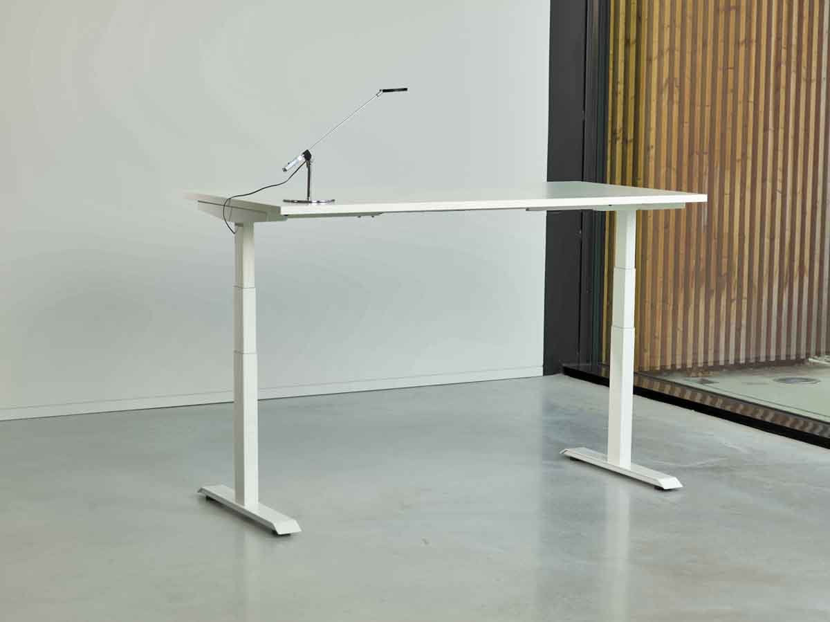 white venta t sit stand desk at standing height in an office