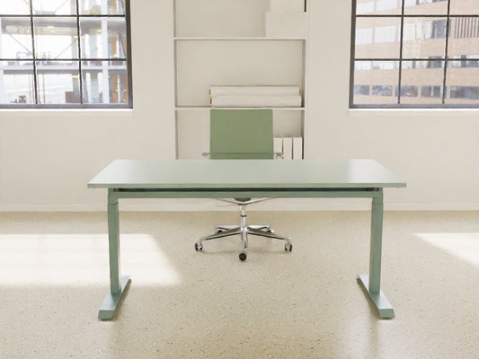 fjord green venta t sit stand desk in a bright office